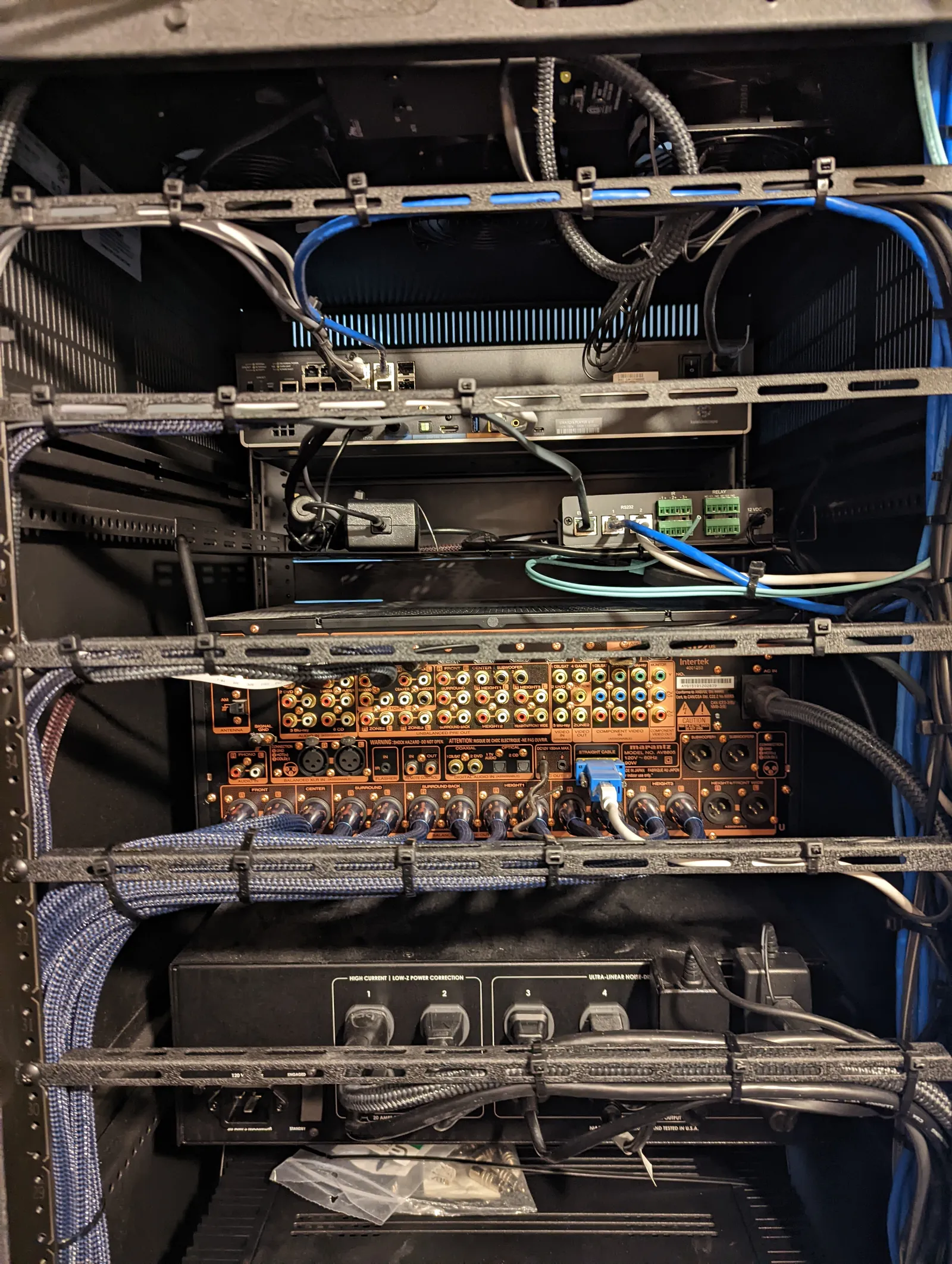 Rear of equipment rack with processor and amplifiers wired, cables dressed and loomed